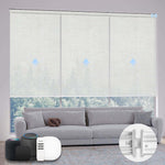 Motorized beige light-filtering coupled roller shades on large windows, softening sunlight and creating a cozy indoor space.