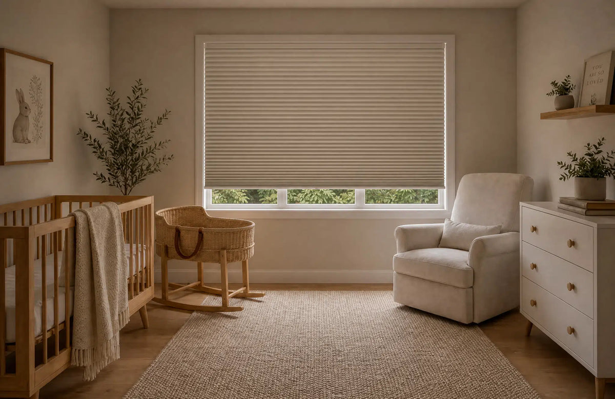 Cordless blackout cellular shades partially lowered over a nursery window for soft light and privacy