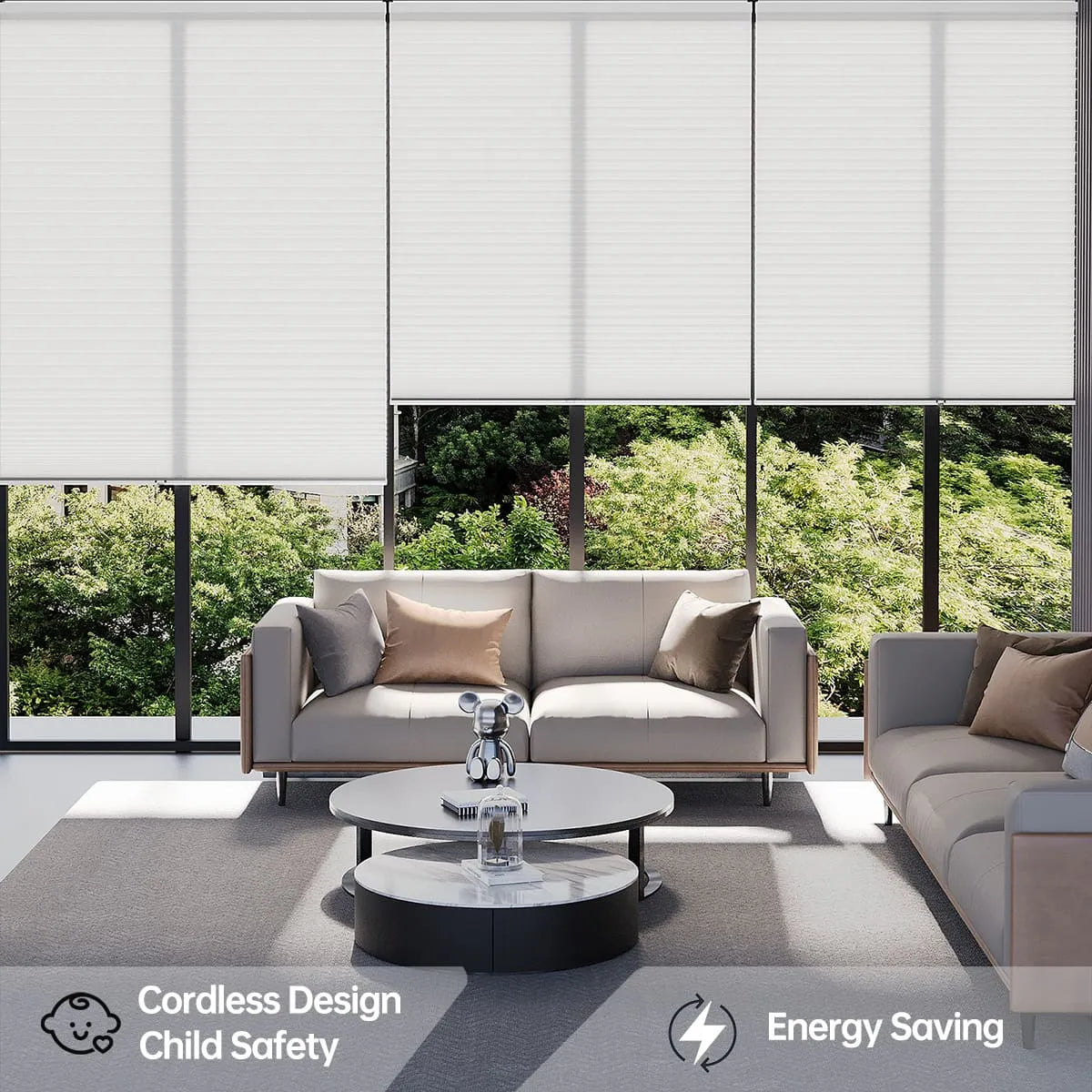 Modern living room with two sofas, a round coffee table, and large windows covered by white cordless cellular shades. Energy saving and child safety icons appear at the bottom.
