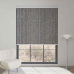Dark grey textured motorized blackout roller shade, blending modern design with full light blocking while keeping an outdoor view.