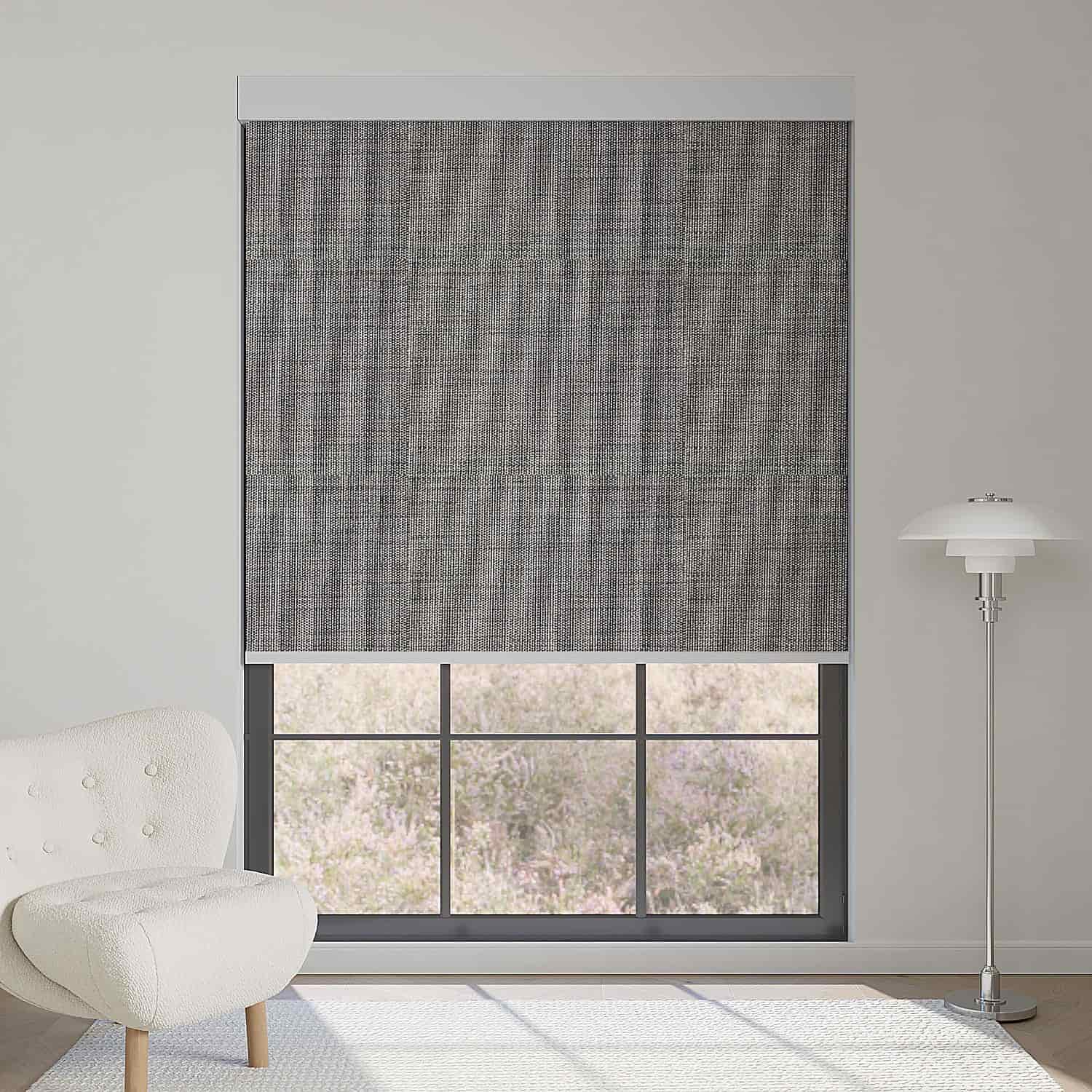 Dark grey textured motorized blackout roller shade, blending modern design with full light blocking while keeping an outdoor view.