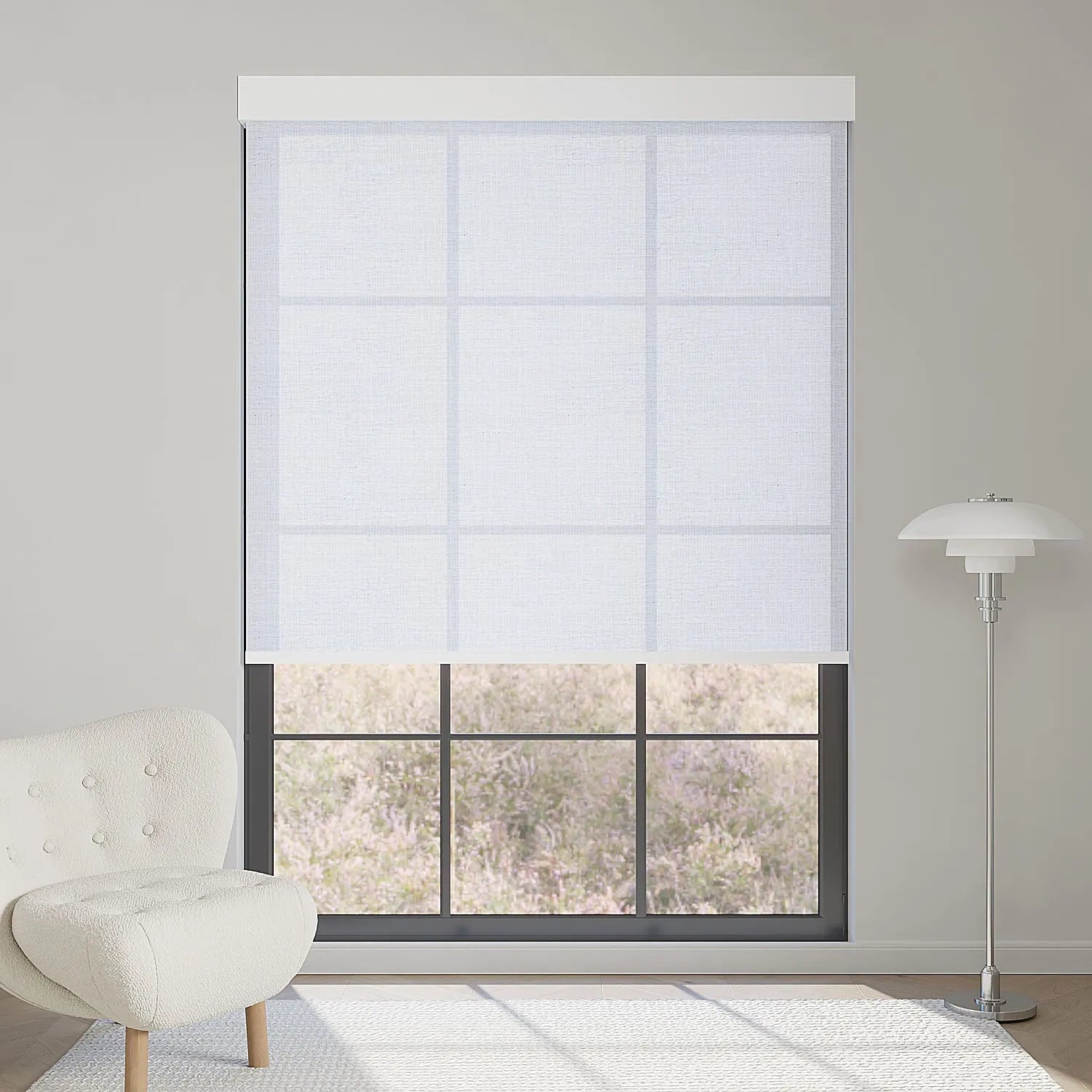 Minimalist plain white light filtering roller shade softly diffuses sunlight, creating a clean, bright, modern interior.