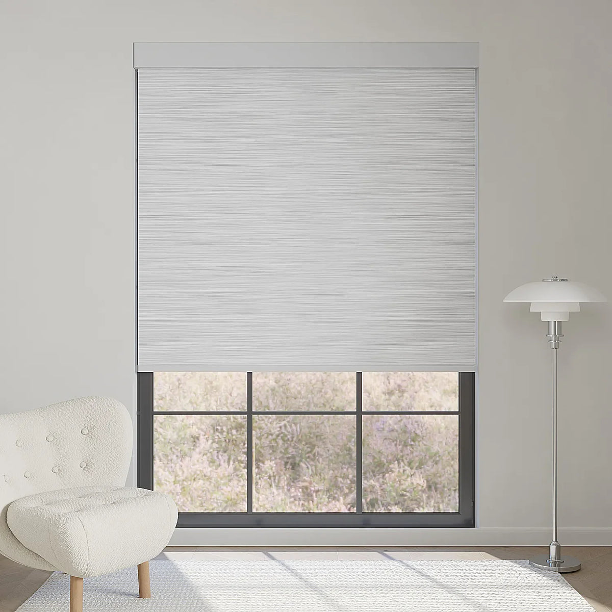 Foggy grey textured motorized blackout roller shade softens sunlight while maintaining outdoor view, adding subtle elegance to the room.