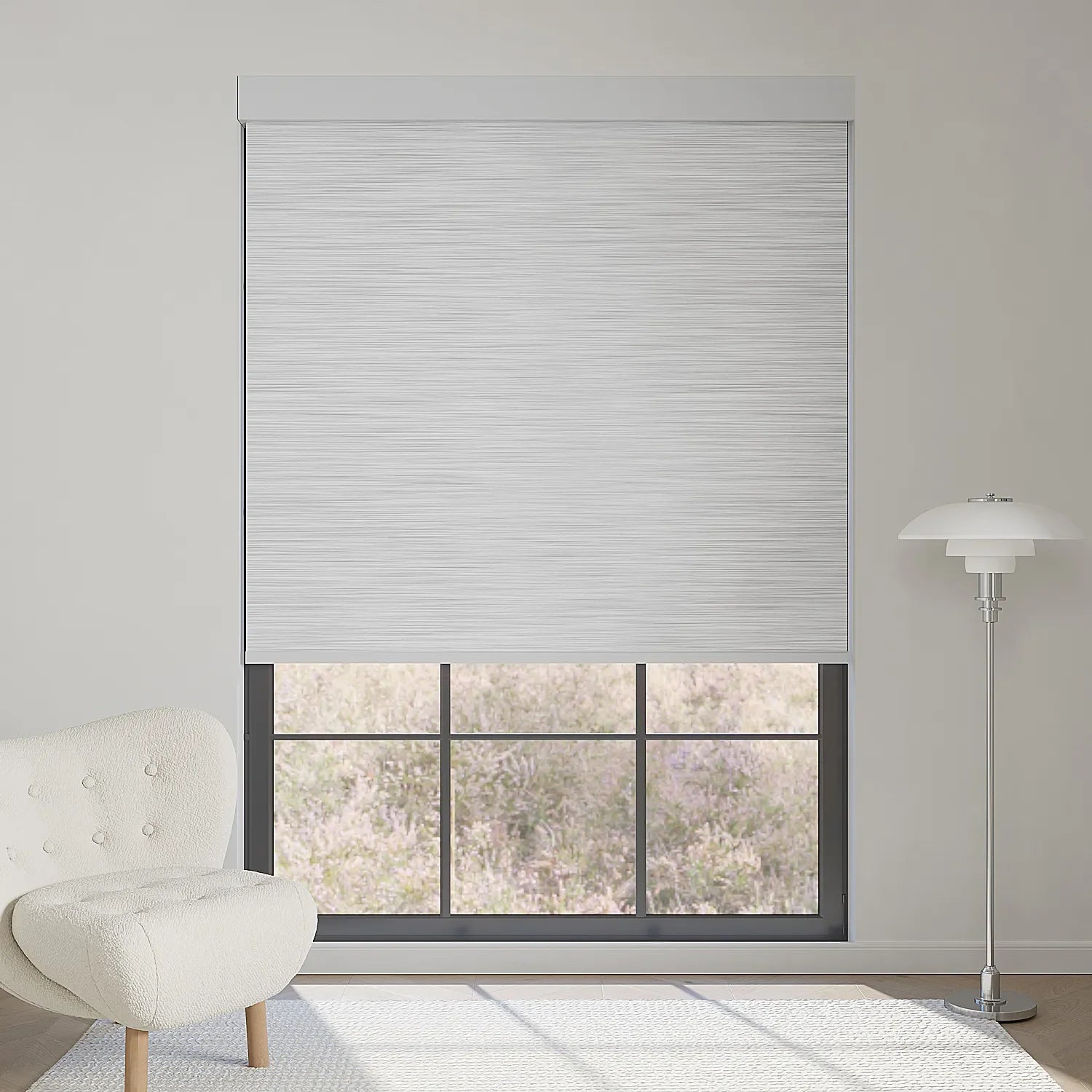Foggy grey textured motorized blackout roller shade softens sunlight while maintaining outdoor view, adding subtle elegance to the room.